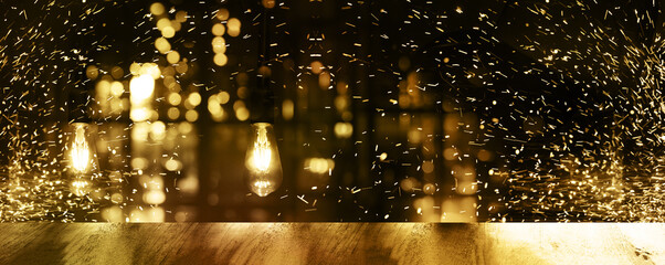 Obraz premium top of wood table with light reflection blur bar or club in the dark night golden light for luxury party abstract banner background