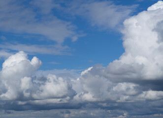 Abstract background texture of white clouds and blue sky. Thick cumulus clouds. Copy space
