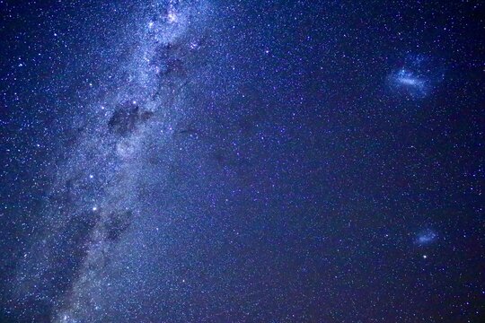 天の川の中で光る南十字星と大マゼラン雲と小マゼラン雲の南天の星空【ニュージーランド】
