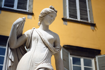 San Salvatore square in Lucca (Tuscany, Italy), detail of the ancient fountain statue of venus with yellow background © Alessandro Cristiano