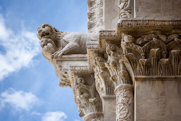 Lucca (tuscany, italy). Detail of the facade of the cathedral of San Martino, with a lion shaped monster emerging from a column capital