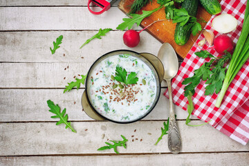 cold kefir soup in glass bowl with spicy herbs