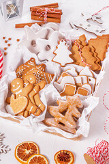 Top view of unpacked christmas present with sweets on a white textured surface, close-up. Christmas celebration concept