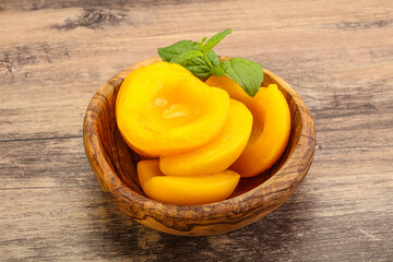 Sweet ripe canned peaches with mint