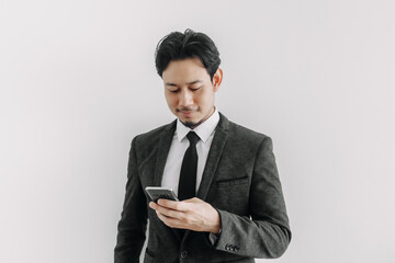 Confidence and successful face of Asian businessman use phone application.