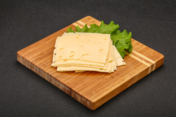 Sliced yellow cheese over board