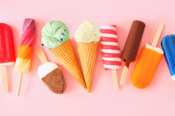 Variety of colorful summer popsicles and ice cream treats. Overhead view scattered on a pink background. - Powered by Adobe
