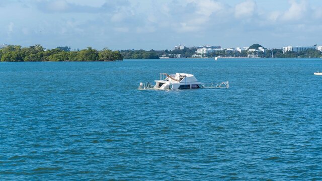Abandoned and derelict vessels (ADVs) being picked up off of Pelican Harbor near the city of North Bay Village, Florida.