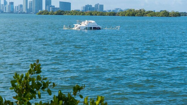 Abandoned and derelict vessels (ADVs) being picked up off of Pelican Harbor near the city of North Bay Village, Florida.