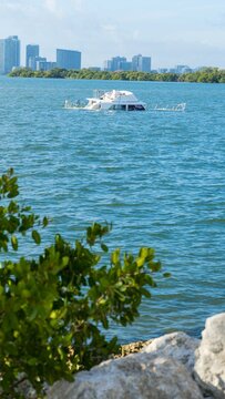 Abandoned and derelict vessels (ADVs) being picked up off of Pelican Harbor near the city of North Bay Village, Florida.