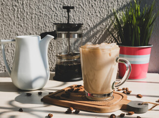 Iced cold coffee in the summer heat. Cold brew coffee with milk cream.
