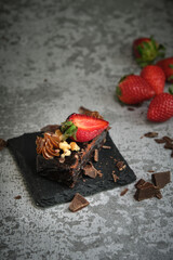 chocolate cake with strawberries on a gray background
