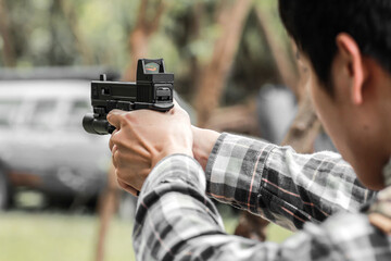 Pistol handgun weapon in shooter hand