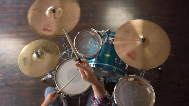 HIGH ANGLE SHOT Music Production Studio. Creative World. Man Doing Stick Tricks. Drummer showing drum stick spinning method