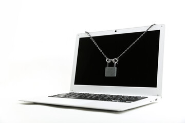 computer with chain and padlock on a white background. concept of limiting access to a computer....