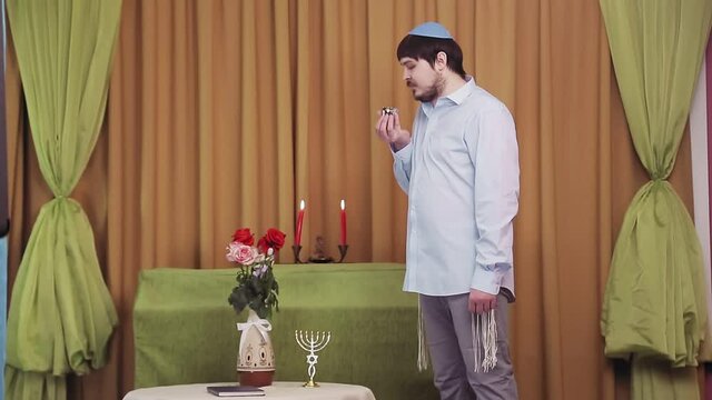 Before the chuppah ceremony, the Jewish groom is in the synagogue hall and makes kiddush for wine