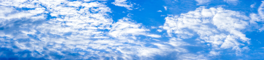 Naklejka na ściany i meble Beautiful clean sunny blue sky with white clouds panorama