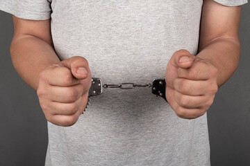 a man in handcuffs arrested was detained by law enforcement agencies