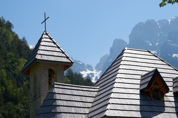 stone church with cross in the mountains in spring