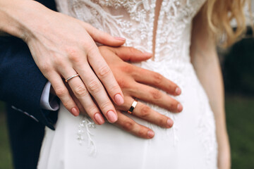 The bride and groom put on each other wedding rings. Wedding ceremony.