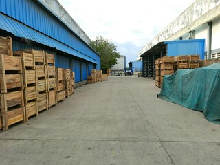 Outdoor view of factory with lot of loads stacked outside the building in wooden boxes