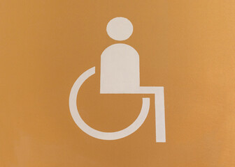 White and yellow sign painted on floor of an underground parking lot - places for disabled people.