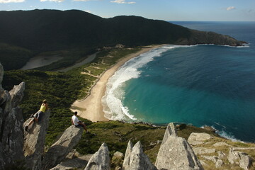 Hikers look over Lagoinha do Leste beach, in Florianopolis, Santa Catarina, Brazil