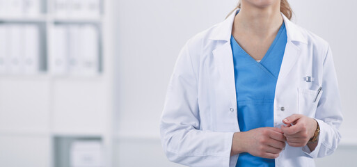 Woman doctor standing with stethoscope at hospital