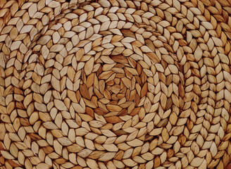 Background with round large weaving of straw. Textured bamboo background.
