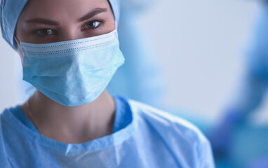 Team surgeon at work in operating room.