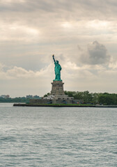 Fototapeta premium Ferry and Statue of Liberty , world famous travel destination composed with beautiful sky and clouds.