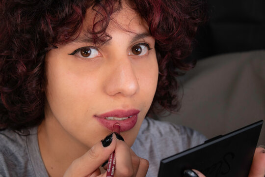 Young, Good Looking Homosexual Man With Red Hair, Putting Make-up On Using Lipstick