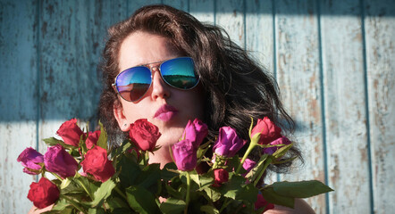 Portrait of a woman in sunglasses with roses