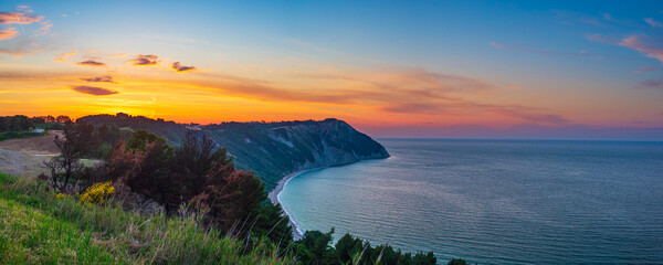 Sunset landscape Conero natural park dramatic coast headland rocky cliff adriatic sea beautiful sky colorful horizon, tourism destination Italy