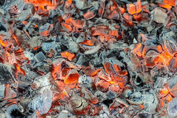 Background of red and black coals close-up for design.
