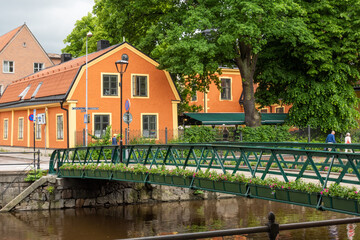 Orange houses near the canal (Fyris River) in Uppsala Downtown, Sweden