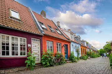 Fototapeta na wymiar Aarhus, Denmark; June 12th, 2021 - Colourful old cottages on a quiet street in Aarhus, Denmark