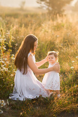 Mother and daughter in sunny photos play among dandelions 3020.