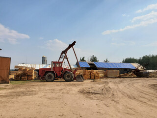 Lumber Warehouse with Tractor. Sawmill industry