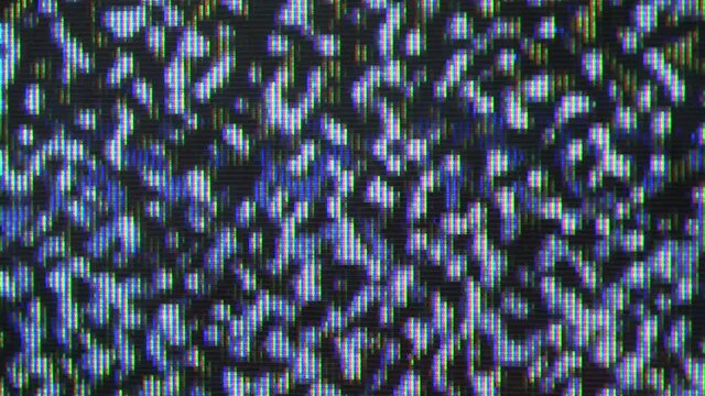 Close up view at a plasma tv while showing white noise .