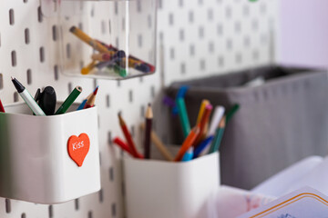 Pencil cup with pencils attached to the wall, design, school, close-up.