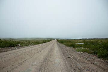 a road in the far north leading into the fog