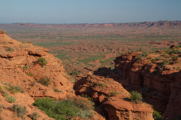 Travel. Desert landscape. Panorama view of the red desert, sandstone, cliffs and rocky mountains under a blue sky in Sierra de las Quijadas national park in San Luis, Argentina.