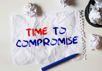 text TIME TO COMPROMISE written on notepad with calculator, pensil, magnifier and dollars.