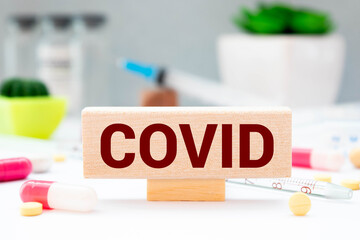 Test result of a Corona test. Hand turns a dice and changes the expression positive COVID19 to negative COVID19