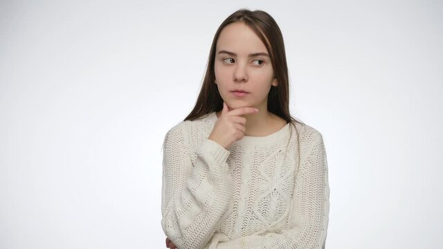 Studio shot of thoughtful teenage girl thinking over white background