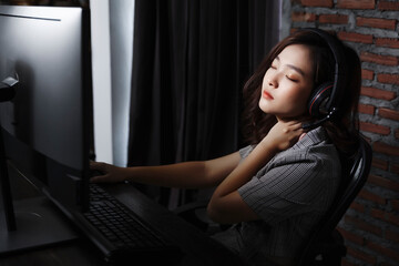 Asian Gamer girl woman nerdy geek casual playing video games computer cheering tired sleepy...