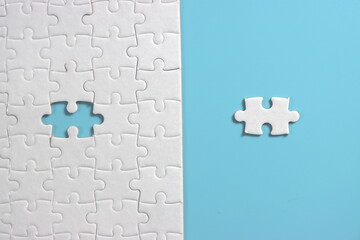 Jigsaw puzzle with missing piece. Missing puzzle pieces. Concept image of unfinished task. Completing final task, missing jigsaw puzzle pieces and business concept with a puzzle piece missing. blue