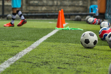 Soccer ball tactics on grass field with cone