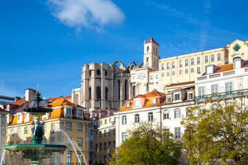 Fototapeta na wymiar Lisbon, Rossio Square fountain and colorful historic buildings of historic city center.